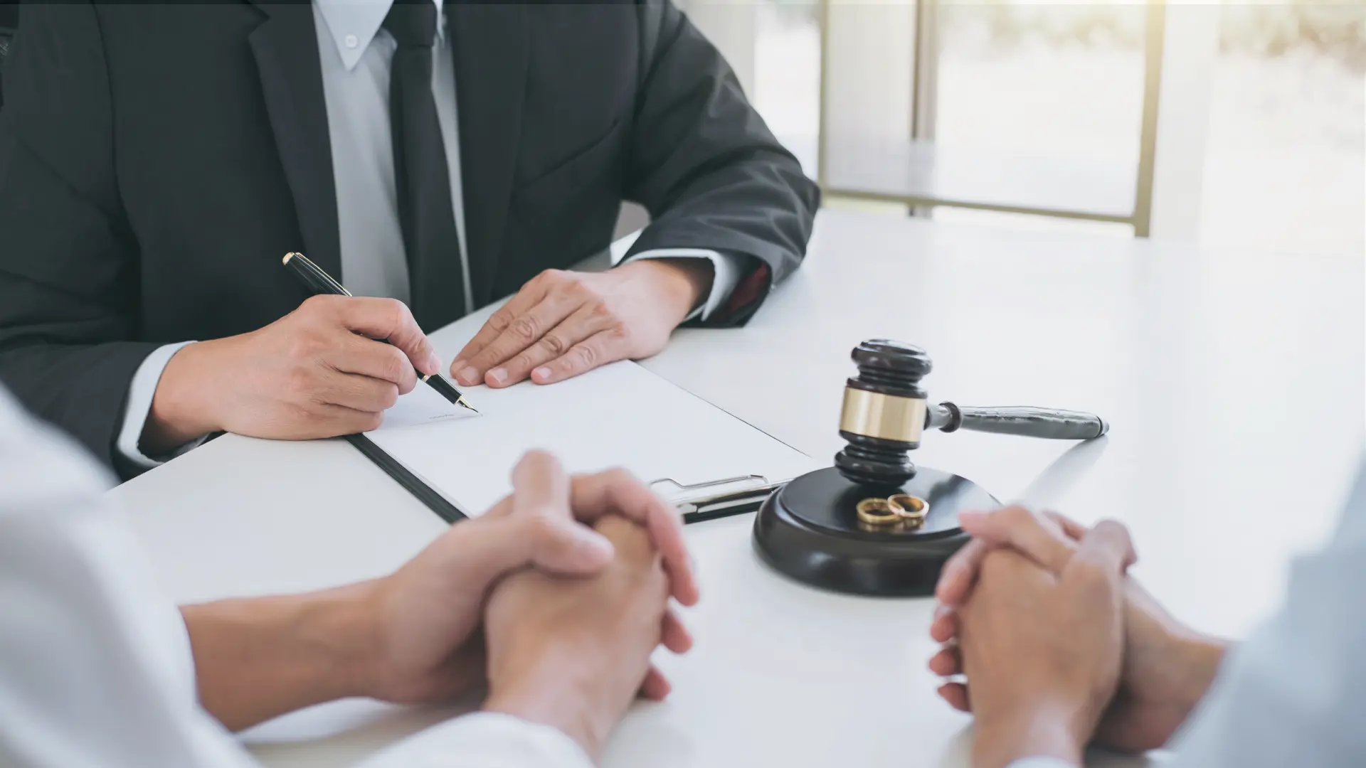 texas divorce lawyer signing documents with their 2 clients