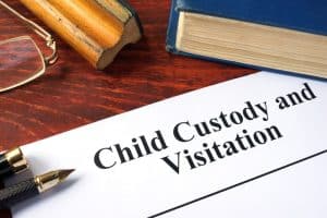 child custody and visitation document on a desk next to other office supplies