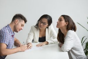 couple speaking to a child custody lawyer in austin filling out child custody documents