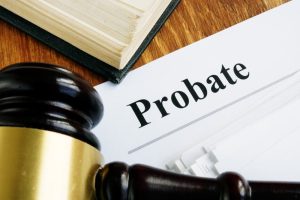 probate document next to a gavel and textbook