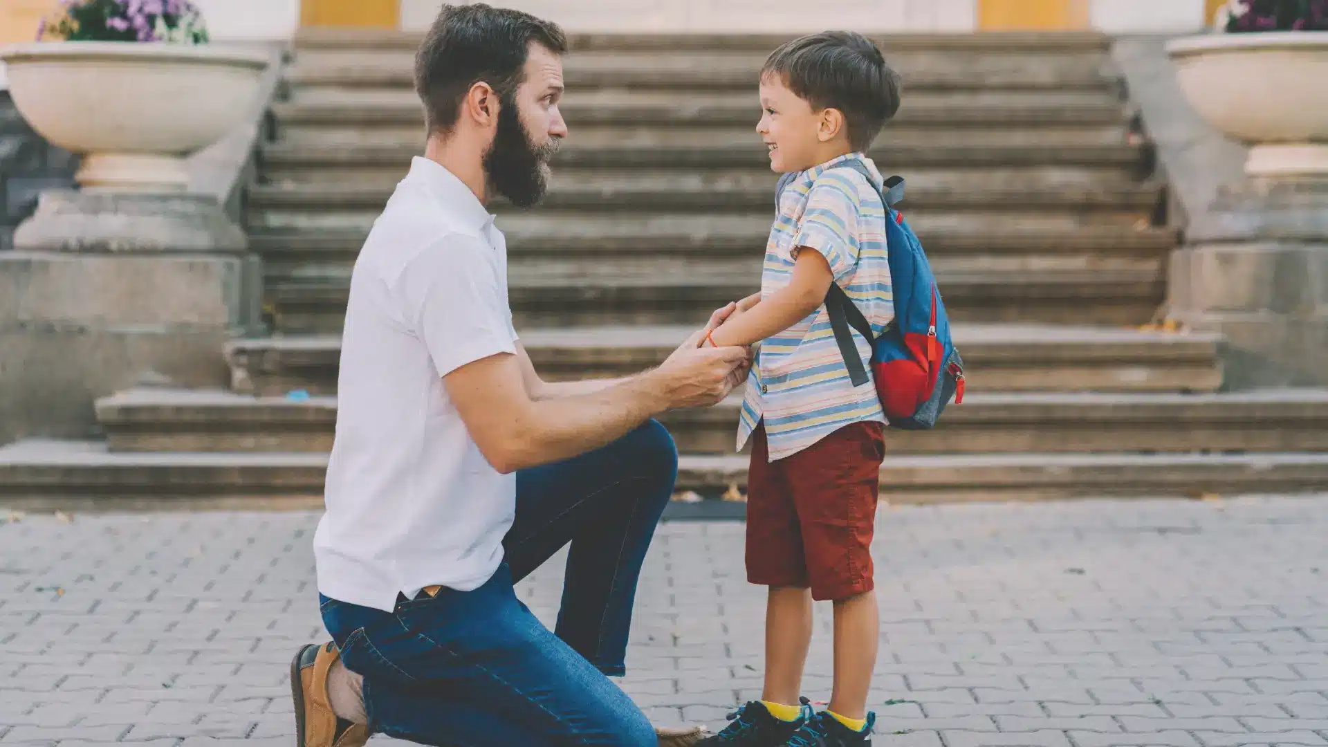 a single parent speaking to their adopted child at eye level