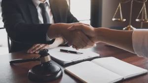 an adoption lawyer in austin texas shaking the hand of a client
