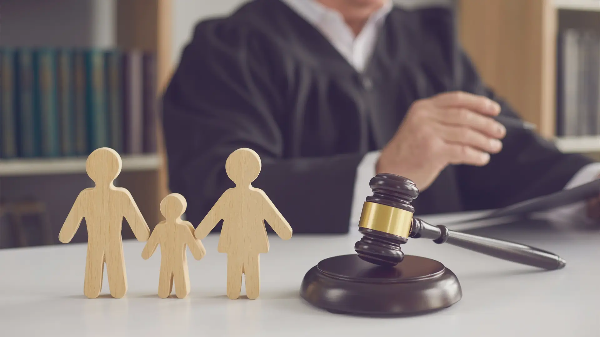 concept of a family stick figures and a family law judge with a gavel