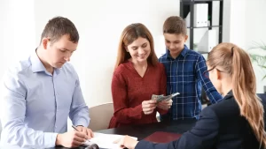 a couple with their child speaking with a child support lawyer in texas and the mom counting her child support money