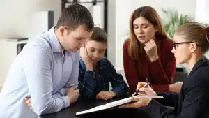a couple and their child speaking with a family law lawyer in texas regarding child support payments