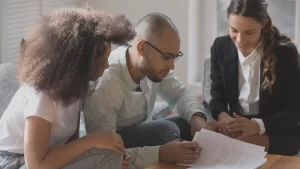 an adoption lawyer in austin texas in a meeting with two people who want to adopt internationally