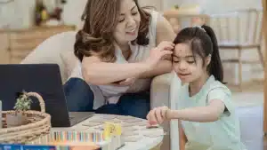 a woman and an adopted girl with special needs playing a game