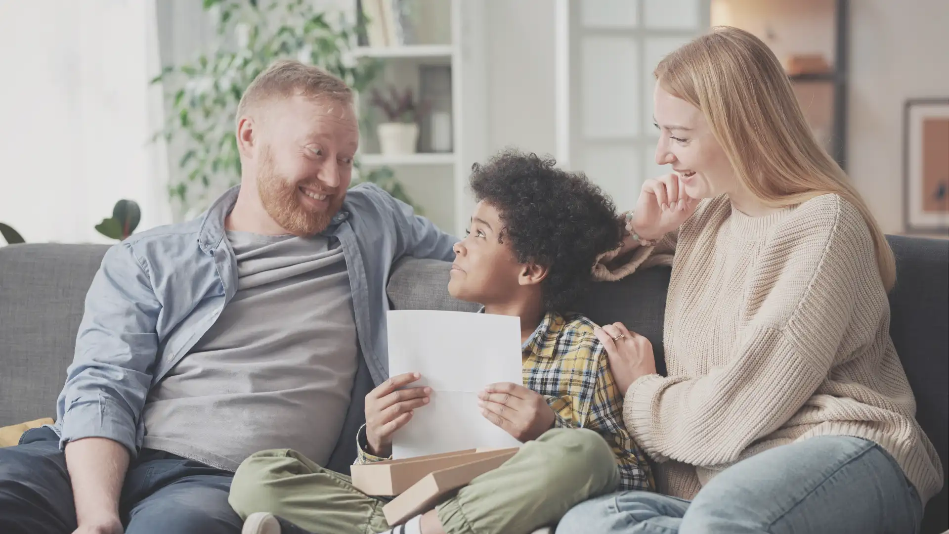 Foster Parents sitting on the couch with the child get paid in texas