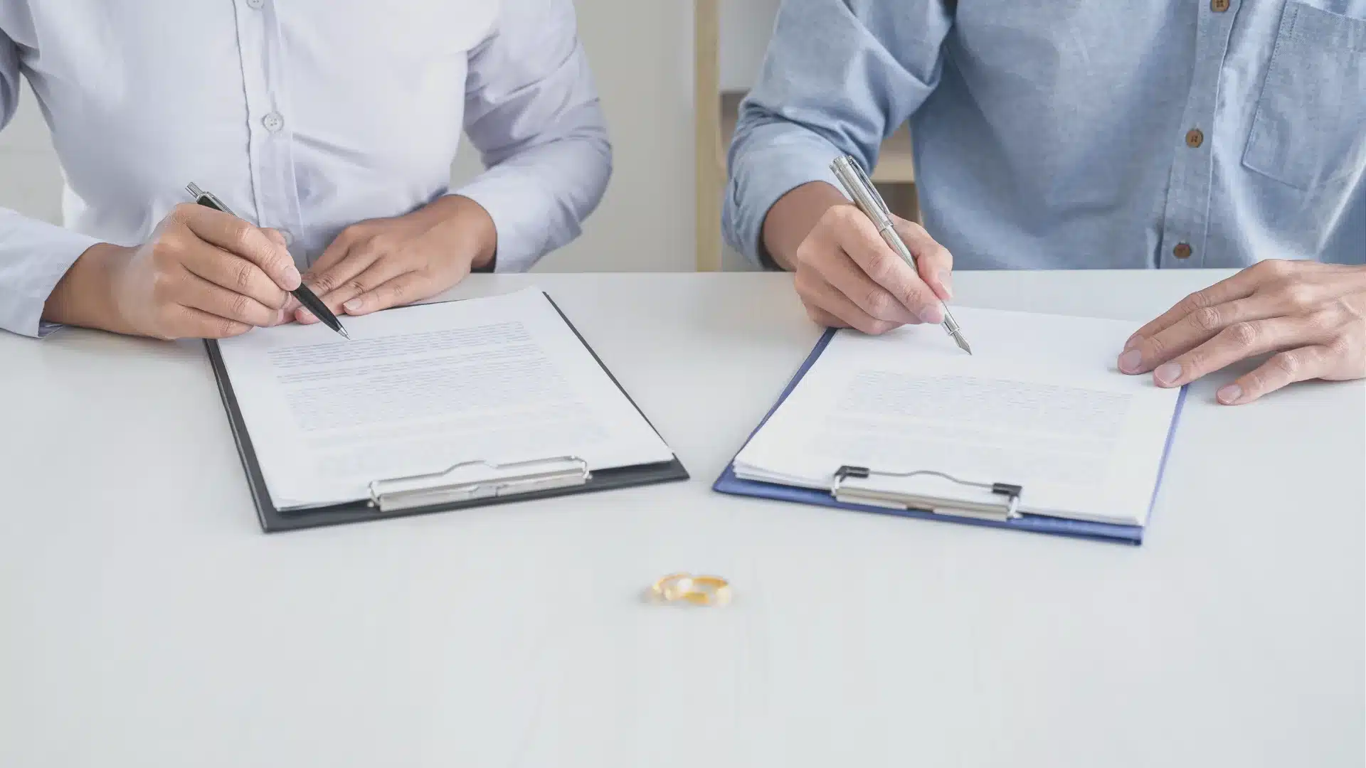 two people signing a document as served divorce papers in texas