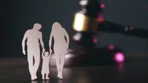 a close-up of a family facing a gavel on the table