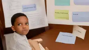 a young boy sitting in front of a whiteboard needs to decide which parent to live with in texas