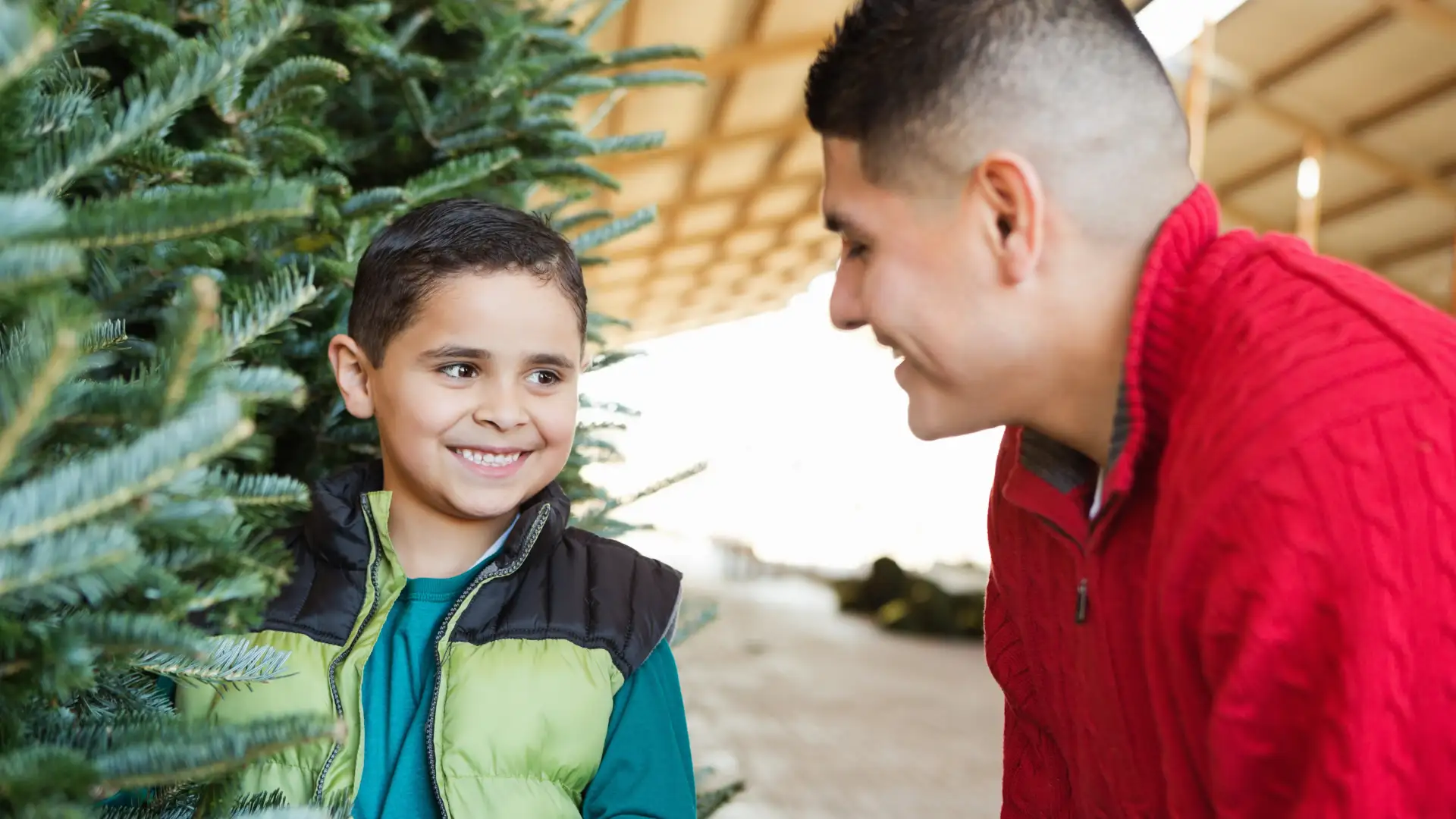 a man and a little girl looking at each other smiling