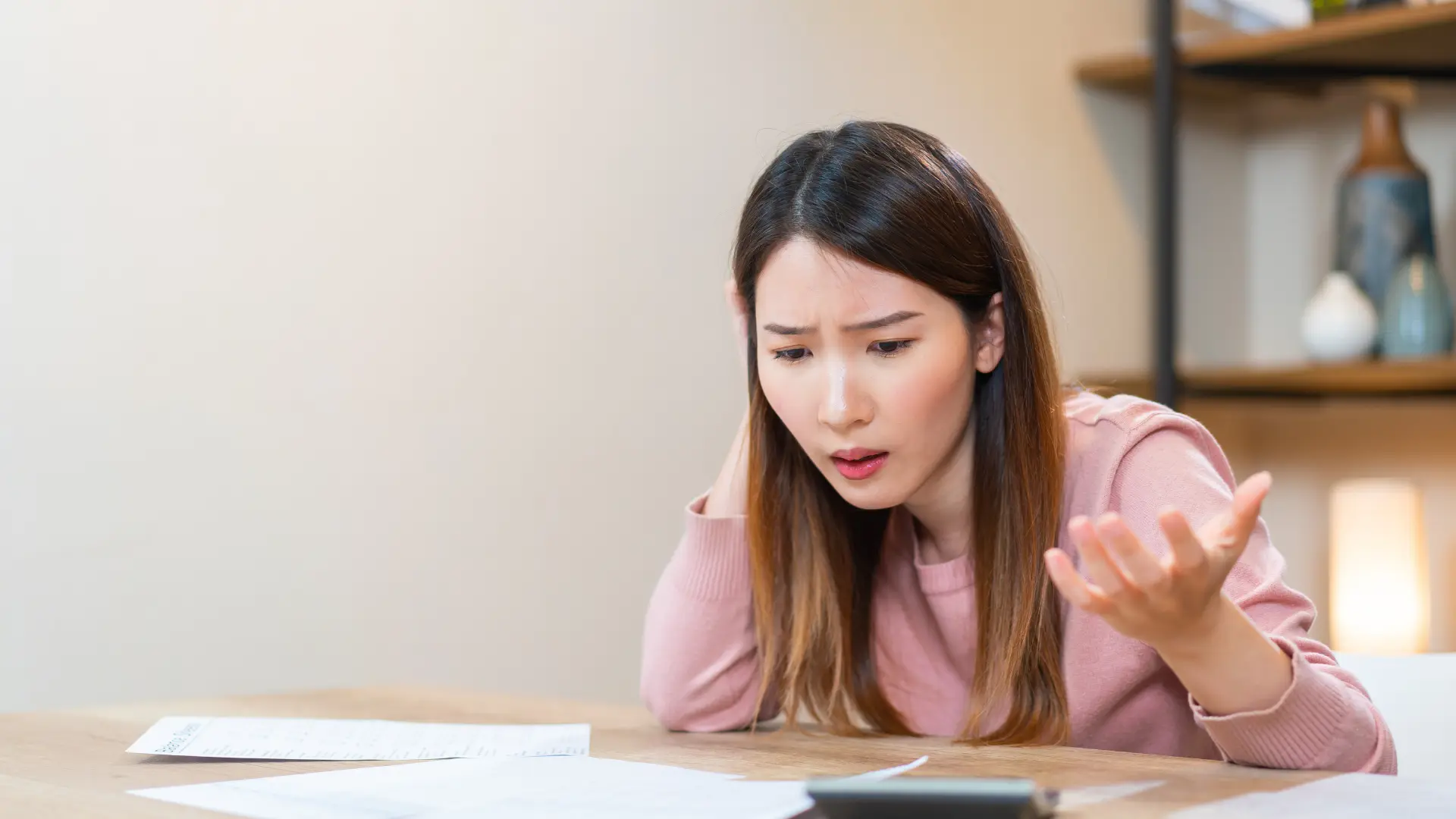 a woman looking at a calculator