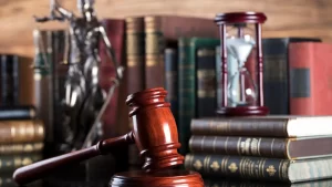 a gavel and hourglass on a table 