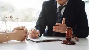 a family law attorney talking to a woman with a gavel on the table