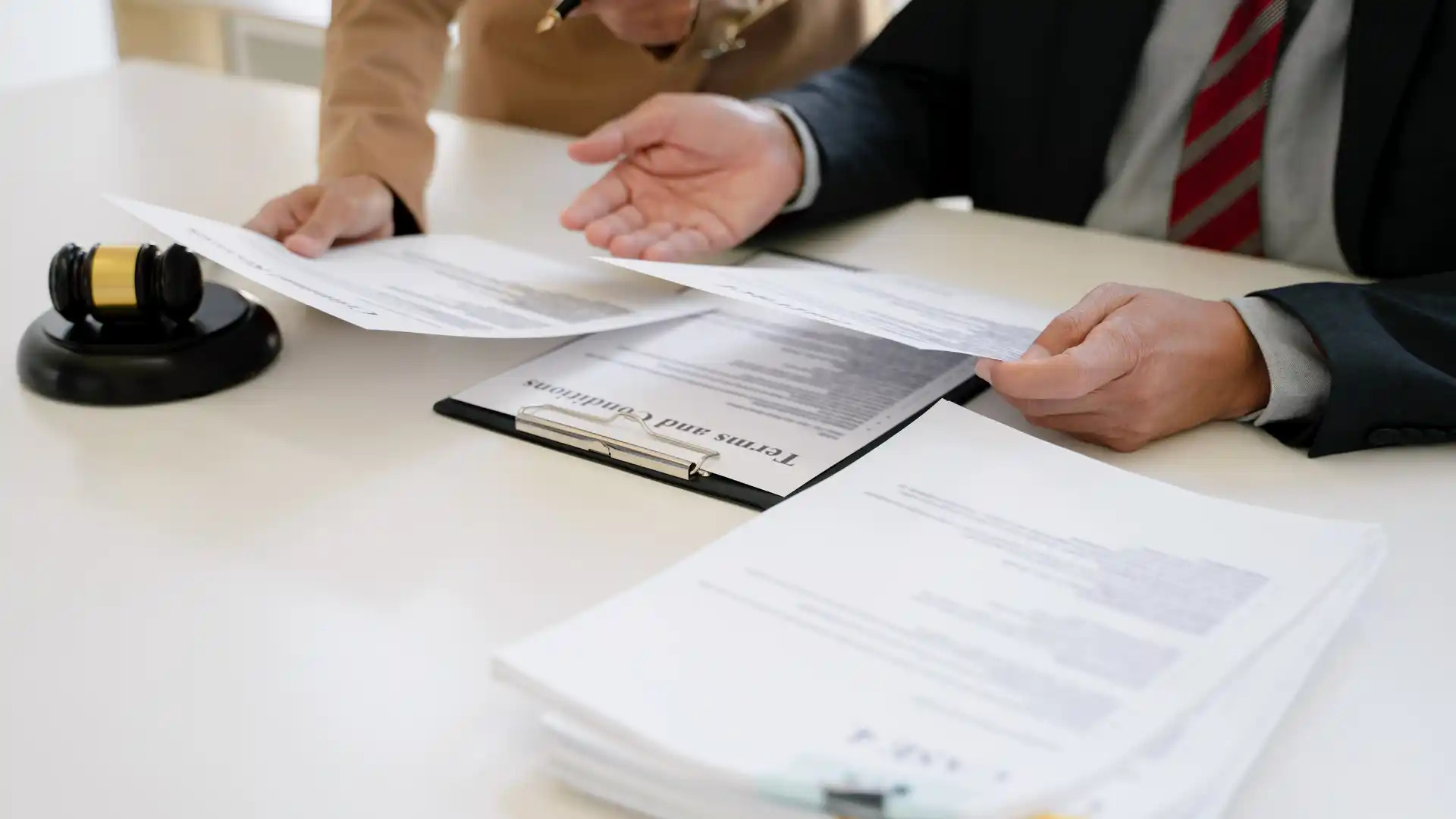 People reviewing divorce and financial documents at a table.