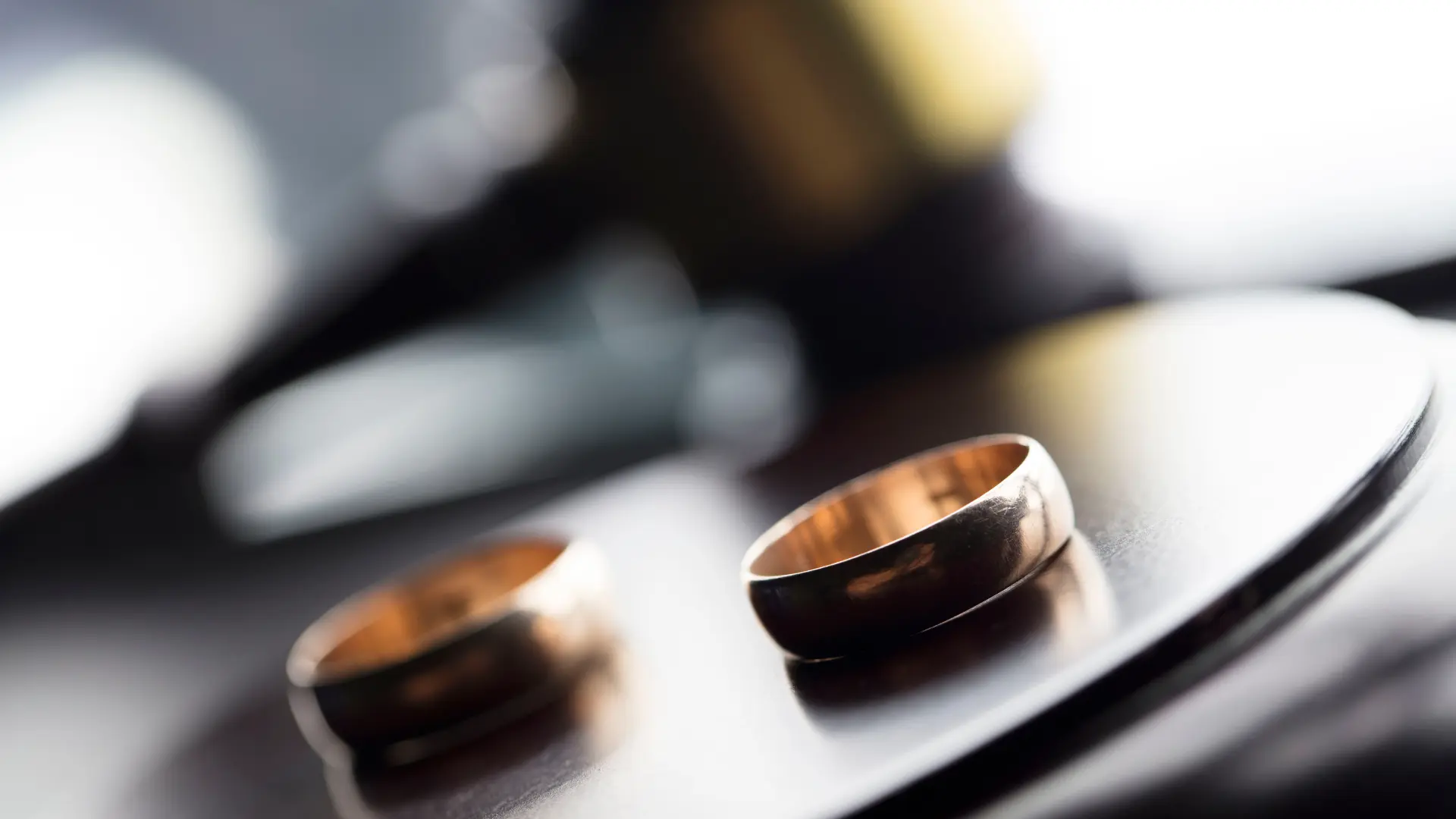 Two wedding rings placed on a table, symbolizing divorce or separation